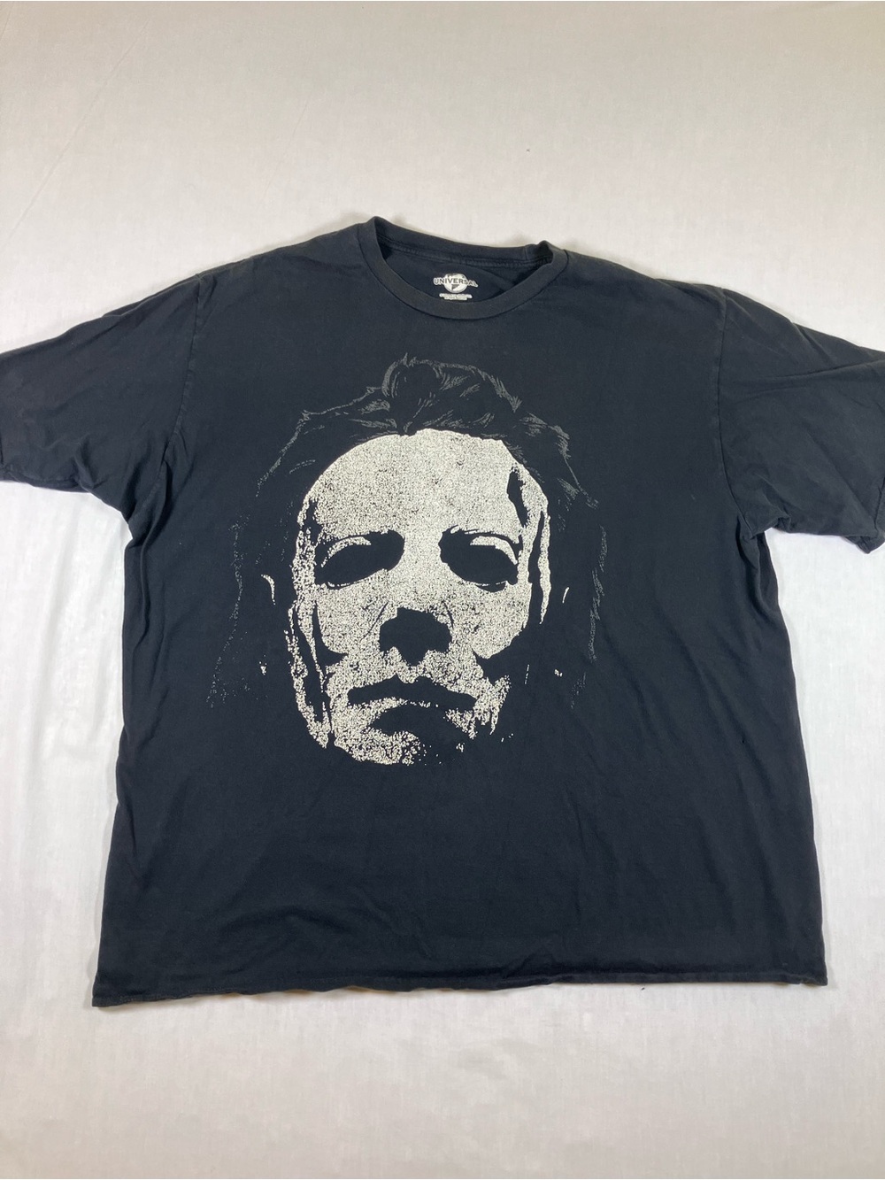 Universal Black Short-Sleeve Tee with Large White Horror Face Graphic